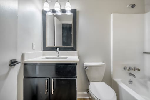 A bathroom with a sink, toilet, and bathtub.at Iris Luxury Apartments, Tennessee  