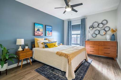 A bedroom with a bed, nightstand, and a ceiling fan.at Iris Luxury Apartments, Tennessee, 38105