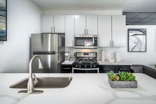 A modern kitchen with a stainless steel refrigerator, microwave, and oven.at Iris Luxury Apartments, Memphis, 38105  