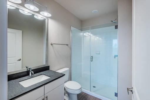 a bathroom with a toilet sink and shower at The Livano Kemah, Texas, 77565