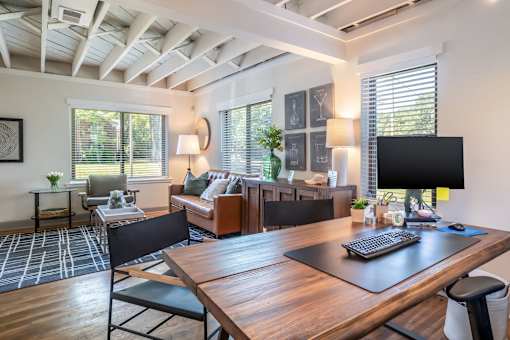 A modern home office with a wooden desk and black chairs at Kiwi Goji Apartments, Tennessee, 38111