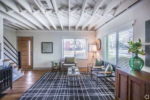 A living room with a black and white checkered rug at Kiwi Goji Apartments, Tennessee