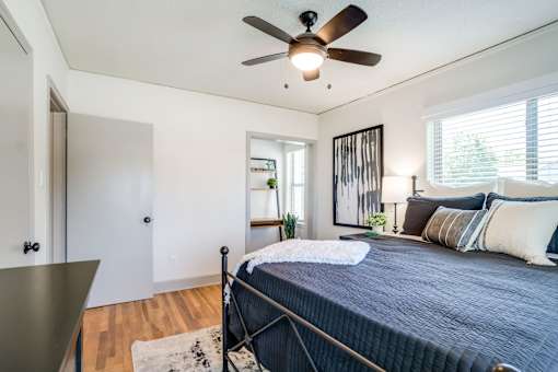 a view of a bed in a bedroom with blue comforter and white blanket at Kiwi Goji Apartments, Tennessee, 38111