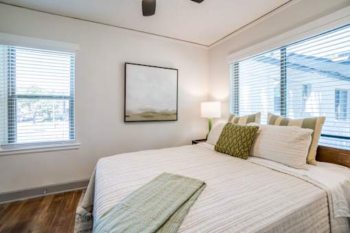 a bed with a blanket and accent pillow at Kiwi Goji Apartments, Tennessee