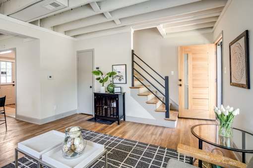 Living Room of a home with a staircase at Kiwi Goji Apartments, Memphis, Tennessee