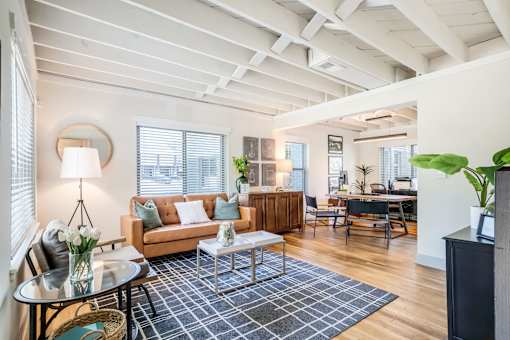 a living room with mid century modern brown and blue accents at Kiwi Goji Apartments, Tennessee