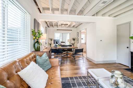 Living Room with a leather couch and desk in distance at Kiwi Goji Apartments, Memphis, TN,  38111