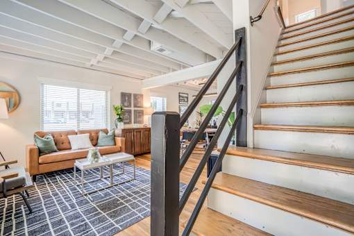 a view of a living room behind a staircase at Kiwi Goji Apartments, Memphis, Tennessee