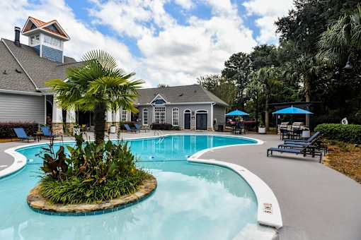 A pool with a small island in the middle of it.