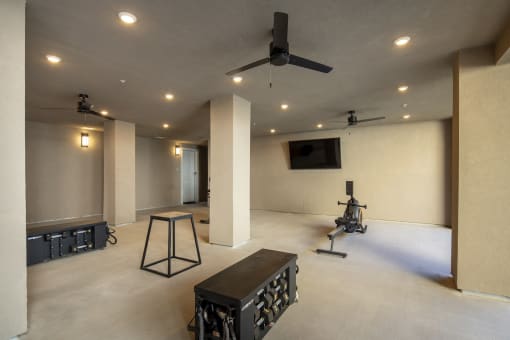 a large room with a ceiling fan and a table in it
