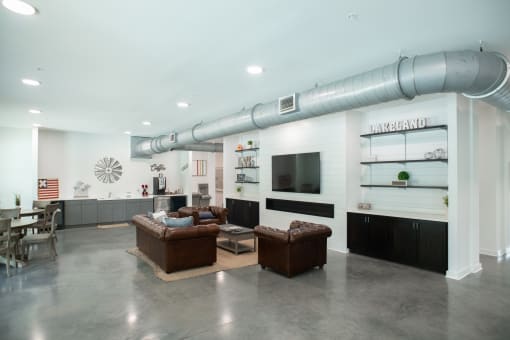 a living room filled with furniture and a large pipe running down the side of a building