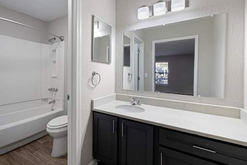 bathroom with a white sink and black cabinets at Manchester at Mansell, Roswell, GA 30076 