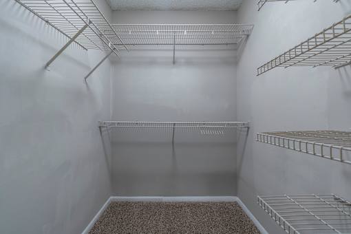 Empty white pantry with shelves and a carpeted floor. at Mill House at East Cobb, Marietta, 30067 