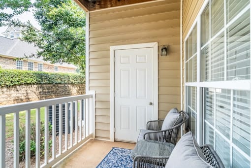 A white door is on the side of a house.