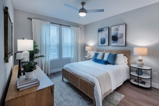 a bedroom with a large bed and a large window at The Livano Kemah, Kemah