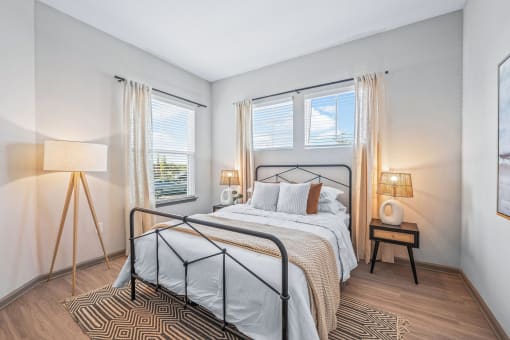 a bedroom with a bed and two windows at Livano Nature Coast, Spring Hill
