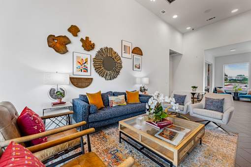 A living room with a blue couch and a coffee table.
