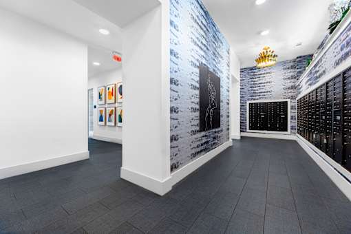 A white wall with a blue brick pattern on the side and a white wall with a black brick pattern on the other side.
