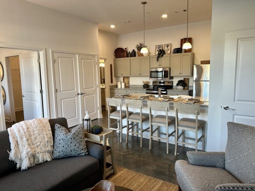 a living room and kitchen with a bar and a couch