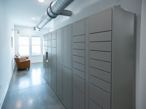 a room with a bunch of lockers and a chair at Lakeland Town Square Apartments, Lakeland