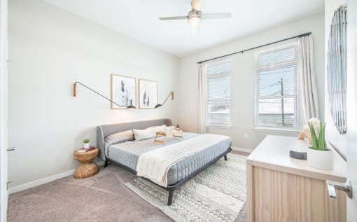 a bedroom with a bed and two windows at The Baxly, Georgia