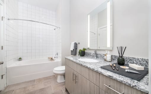 a bathroom with a sink and a toilet and a shower at The Baxly, Savannah, GA