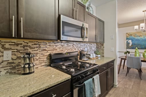 Kitchen with Stainless Steel Appliances located at St. Andrews Apartments in Johns Creek, GA 30022