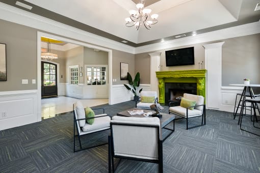 Modern clubhouse with fireplace  located at St. Andrews Apartments in Johns Creek, GA 30022