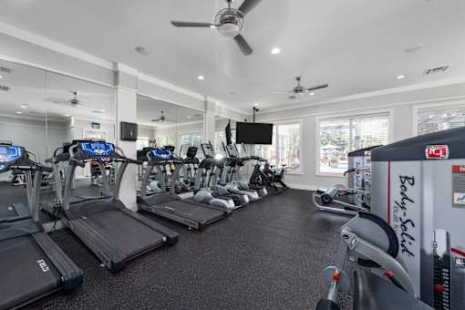 A gym with treadmills and exercise equipment at The Fenwick Apartments, Humble