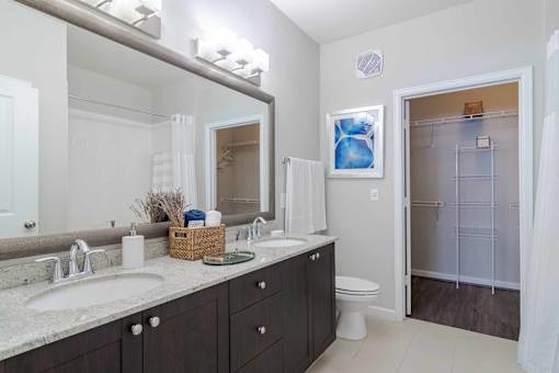 A bathroom with a white toilet and a white sink. at The Ren, Atlanta, 30329