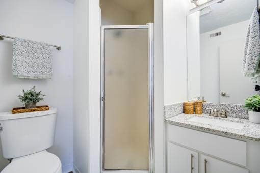 Bathroom with mirror at The Waters at Chenal Apartments, Little Rock, AR