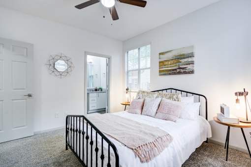Bedroom with bed at The Waters at Chenal Apartments, Little Rock