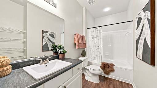 A bathroom with a white toilet and a white sink.
