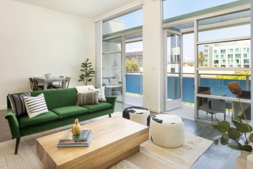 a living room with a green couch and a wooden coffee table
