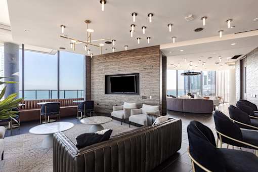 A modern living room with a fireplace and a large couch.