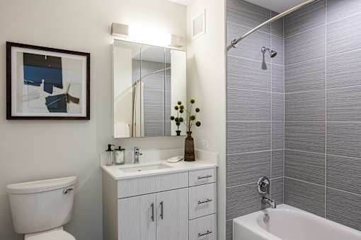 A bathroom with a white toilet, a white sink, and a white bathtub.