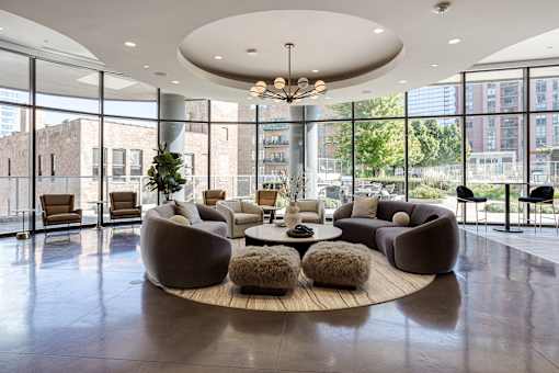 A modern living room with a large circular table and chairs.