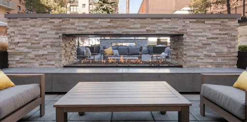 Outdoor lounge area next to a fireplace