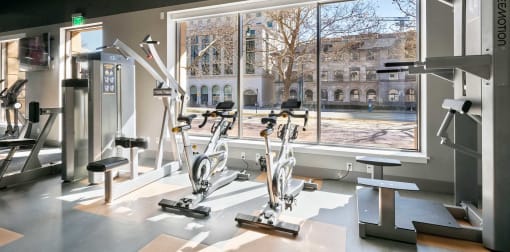 Fitness center with large window view of nearby buildings