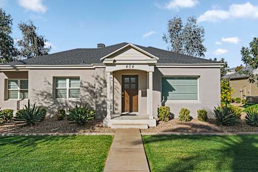 A house with a brown front door and a small porch.