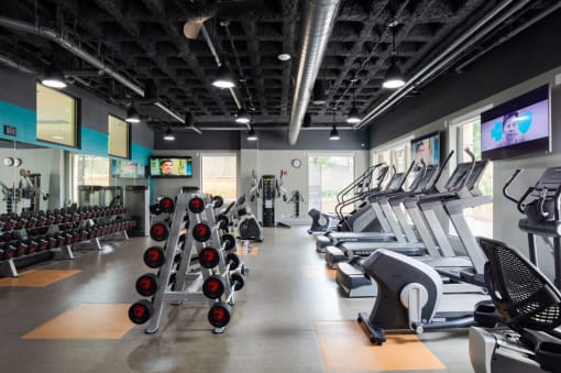 Fitness center with treadmills and dumbbells