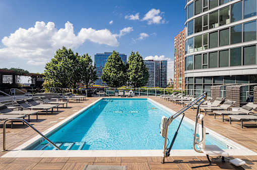 A swimming pool with a metal ladder in the middle of it.