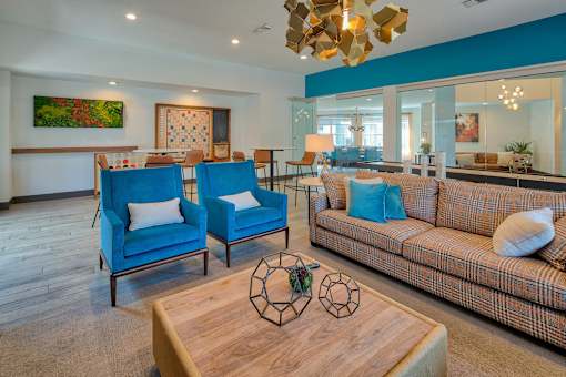 A living room with a blue couch and a wooden coffee table.