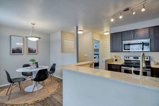 Cedar building -  An open kitchen and dining area with a table and chairs