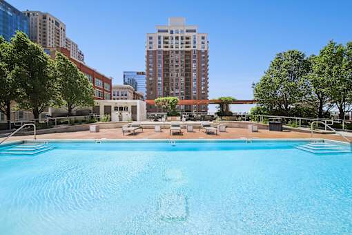 Luxury outdoor pool with lounge seating and skyline views at South Loop Chicago apartments