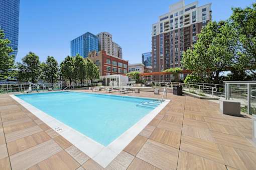 Resort-style pool deck with sundeck chairs and city views in South Loop Chicago residential community