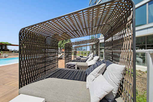 Luxury poolside cabanas at a South Loop Chicago apartment community with shaded lounge seating and skyline views.