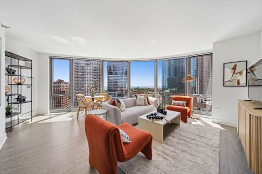 Bright living room with floor-to-ceiling windows and city views in South Loop Chicago luxury apartment