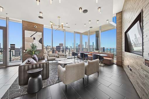 High-rise resident lounge with panoramic Chicago skyline views and luxury seating in South Loop Chicago building
