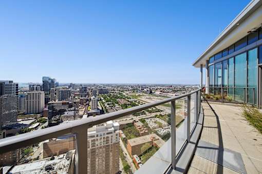 Luxury rooftop terrace with outdoor seating and sweeping Chicago skyline views in South Loop apartments